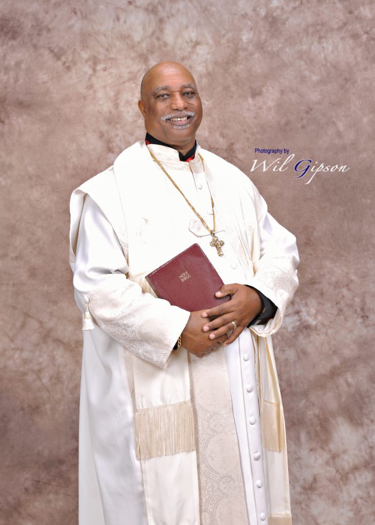 a portrait of vernon whitaker holding a bible
