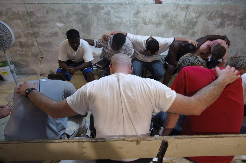 a photo of men praying